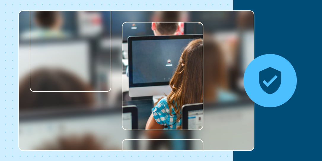 The back of a student's head as she looks at a computer screen